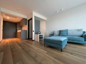 a living room with a blue couch and a chair at Life Hotel in Bergamo