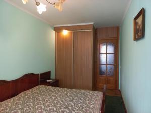 1 dormitorio con cama, ventana y puerta en Apartments in Lviv, en Leópolis