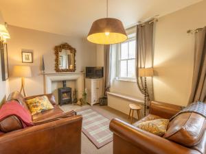 a living room with two couches and a fireplace at 2 Bed in Threlkeld SZ082 in Threlkeld
