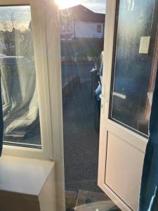 an open door with a view of a driveway at Dream private ensuite apartment in Solihull close to Birmingham airport-city centre and NEC in Birmingham