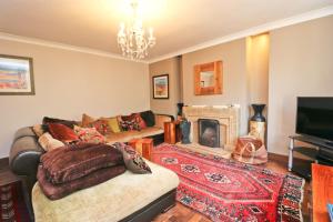 a living room with a couch and a fireplace at Beautiful character cottage in Saint Mawgan