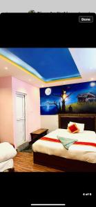 a bedroom with a bed with a painting on the wall at Global hotel in Kathmandu