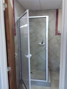 a shower with a glass door in a bathroom at Lupita 3 in General Roca +25 photos