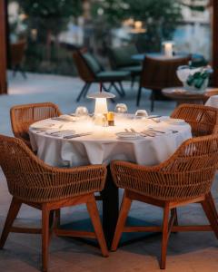 a table with chairs and a white table cloth at City of Dreams Mediterranean - Integrated Resort, Casino & Entertainment in Limassol