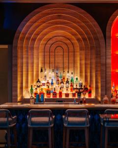 a bar in a room with a display of bottles at City of Dreams Mediterranean - Integrated Resort, Casino & Entertainment in Limassol