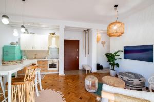 a kitchen and living room with a table and chairs at Piraeus Urban Gem in Piraeus