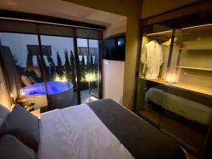 a bedroom with a bed and a window with a tub at Luxury Loft in Bogota with Private Terrace and Jacuzzi in Bogotá