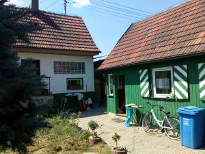 a green and white house with two bikes parked outside at Hexen Haus in Burghaslach