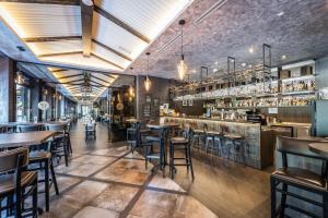 a restaurant with tables and chairs and a bar at HOTEL EUROPA in Komárno