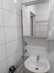 a white bathroom with a sink and a mirror at Ferienhaus Bozena Appartment 3 in Vrsar +8 photos