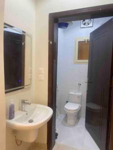 a bathroom with a sink and a toilet at شقق ايلاف طيبة in Al Madinah