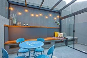 uma sala de jantar com uma mesa azul e cadeiras em Loft 102 em Curitiba