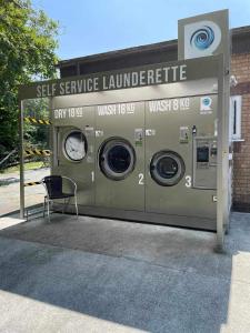 a washer and dryer outside of a building at 180 River View Cabin in Caeathro