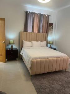 1 dormitorio con 1 cama grande y cabecero grande en Espectacular alojamiento, en Punta Cana