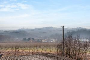 a view of a field with mountains in the distance at Casa Gallinotto in Alba