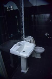 a bathroom with a sink and a toilet at Hotel Sanri Villa Katunayake in Minuwangoda