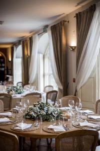 a table with wine glasses and flowers on it at Quinta do Paço Hotel in Vila Real