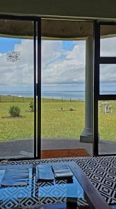 a view of the ocean from a room with a table at Wild Coast Grosvenor Holiday Home in Lusikisiki