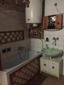 a bathroom with a sink and a bath tub at Romantická drevenica in Liptovská Osada