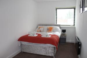 a bedroom with a bed with two mugs on it at ChicCityApartment - Free parking - Perfect for contractors - Close to Molineux Stadium in Wolverhampton