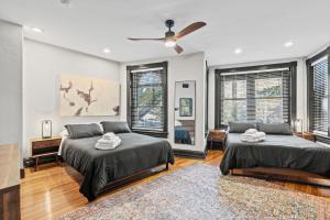 a bedroom with two beds and a ceiling fan at Spacious, Historic Logan Circle Rowhouse in Washington