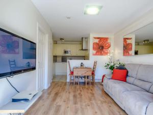 a living room with a couch and a table at 1 Bed in Arrochar 82648 in Arrochar