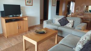 a living room with a couch and a tv at 1722 Marina Park in Lagos