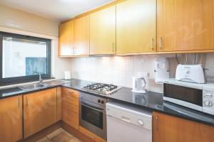 a kitchen with wooden cabinets and a counter top at 1722 Marina Park in Lagos