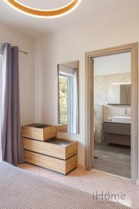a bathroom with a sink and a mirror at Villa Paradiso - Breathtaking Seaview in Iraion