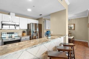 a kitchen with white cabinets and a counter top at South Harbour Unit 2D in Pensacola Beach