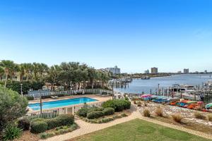 a view of a marina with a pool and boats at South Harbour Unit 2D in Pensacola Beach