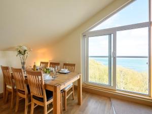 a dining room with a table and a large window at 2 Bed in Torquay 51143 in Torquay