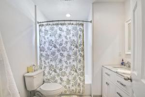 a bathroom with a toilet and a shower curtain at Walk To Beach & Village - 5 Bedrooms - 3 Units in Carlsbad +20 photos