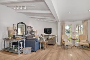 a living room with a blue couch and a mirror at Walk To Beach & Village - 5 Bedrooms - 3 Units in Carlsbad