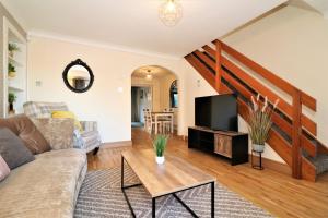 a living room with a couch and a tv at Signature - Shield House in Scotstoun