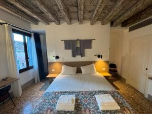 a bedroom with a bed with two pillows on it at TRA SAN MARCO E RIALTO in Venice