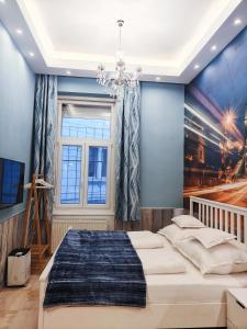 a bedroom with a large bed and a window at King Apartment in Budapest