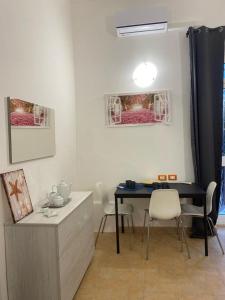 a dining room with a blue table and chairs at Sweet Home Lunì in Vitinia