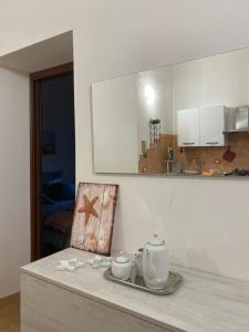 a kitchen with a table with a chair and a mirror at Sweet Home Lunì in Vitinia