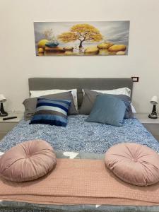 a bed with two pillows on top of it at Sweet Home Lunì in Vitinia