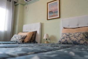 a bedroom with two beds with pillows at Coliving Med by Hotel Mediterràneo in Montevideo