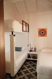 a bedroom with two bunk beds and a desk at Seaflower Boutique lodge in Providencia
