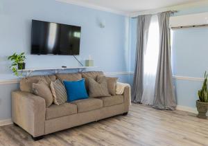 a living room with a couch and a flat screen tv at Arawak Bay: Inn at Salt River in Christiansted