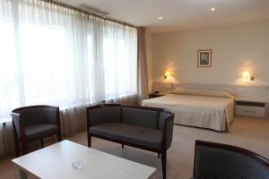 Postel nebo postele na pokoji v ubytování Savoy Hotel