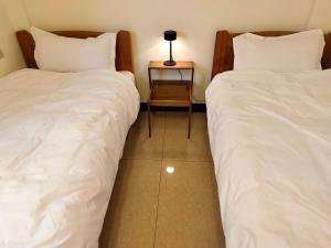 Postel nebo postele na pokoji v ubytování 小憩人輕旅