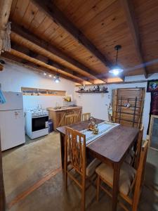 a large kitchen with a wooden table and chairs at Mañana campestre in Chilecito