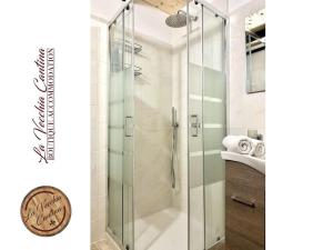 a glass shower in a bathroom with a sink at La Vecchia Cantina in Graniti +50 photos