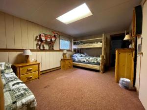 a bedroom with two bunk beds and a lamp at Ryder's Lodge in Old Forge