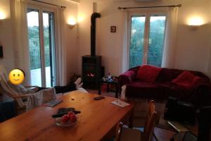 un soggiorno con un tavolo di legno e un divano di Haus mit Pool im Olivenhain a Koroni