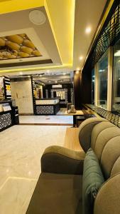 a lobby of a store with couches and a counter at أجنحة بلو روز الفندقية in Najran